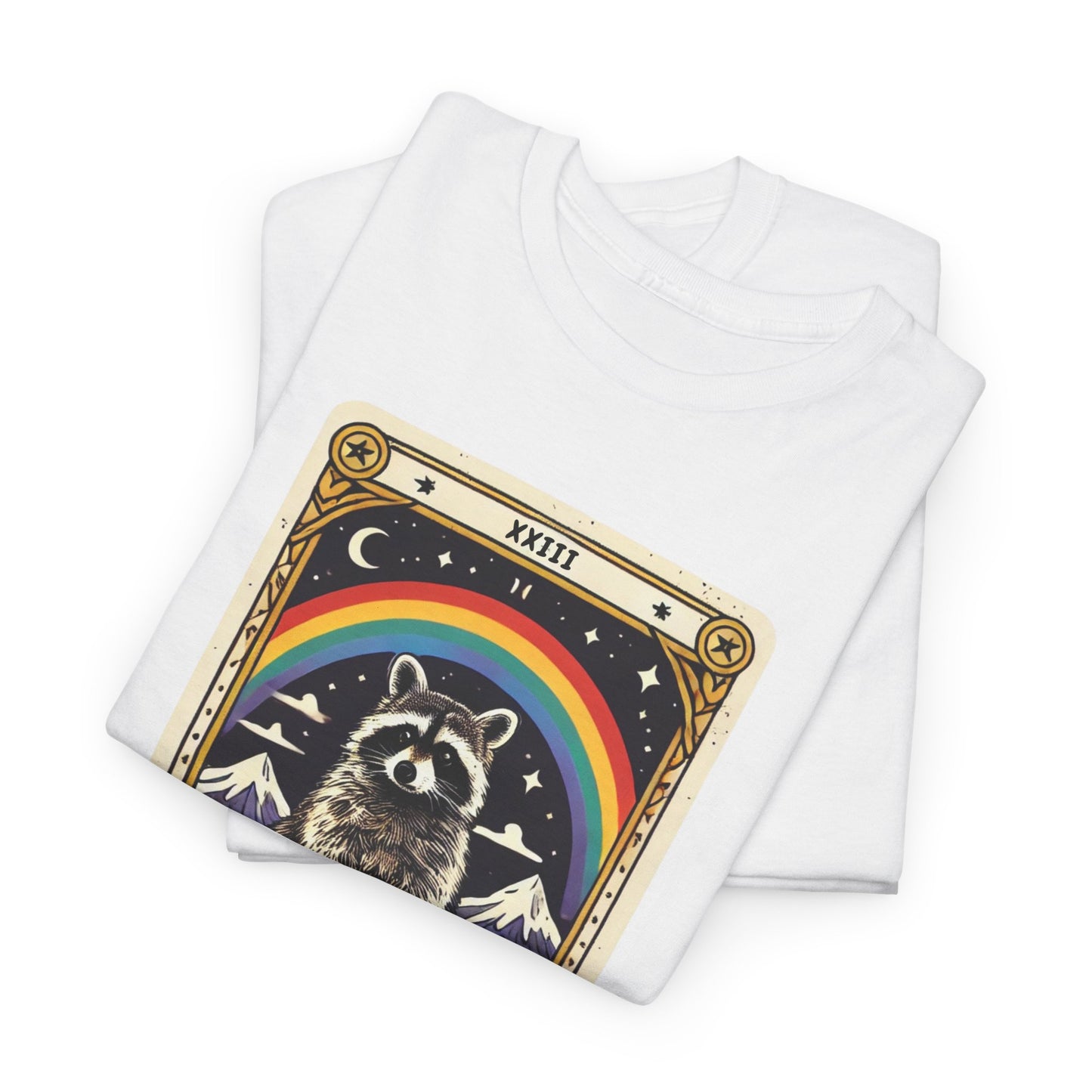 White t-shirt with a tarot card-style design featuring the king of trash tarot card that has a raccoon standing on a trash can under a rainbow. The card has a roman numeral on the top and "King Of Trash" written on the bottom of the card image. The T-shirt is folded on top of another white T-shirt.
