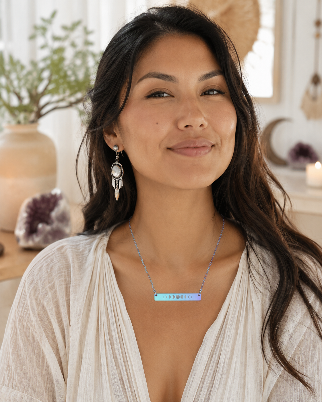 Woman wearing an iridescent necklace with a horizontal bar moon phases pendant in a home setting