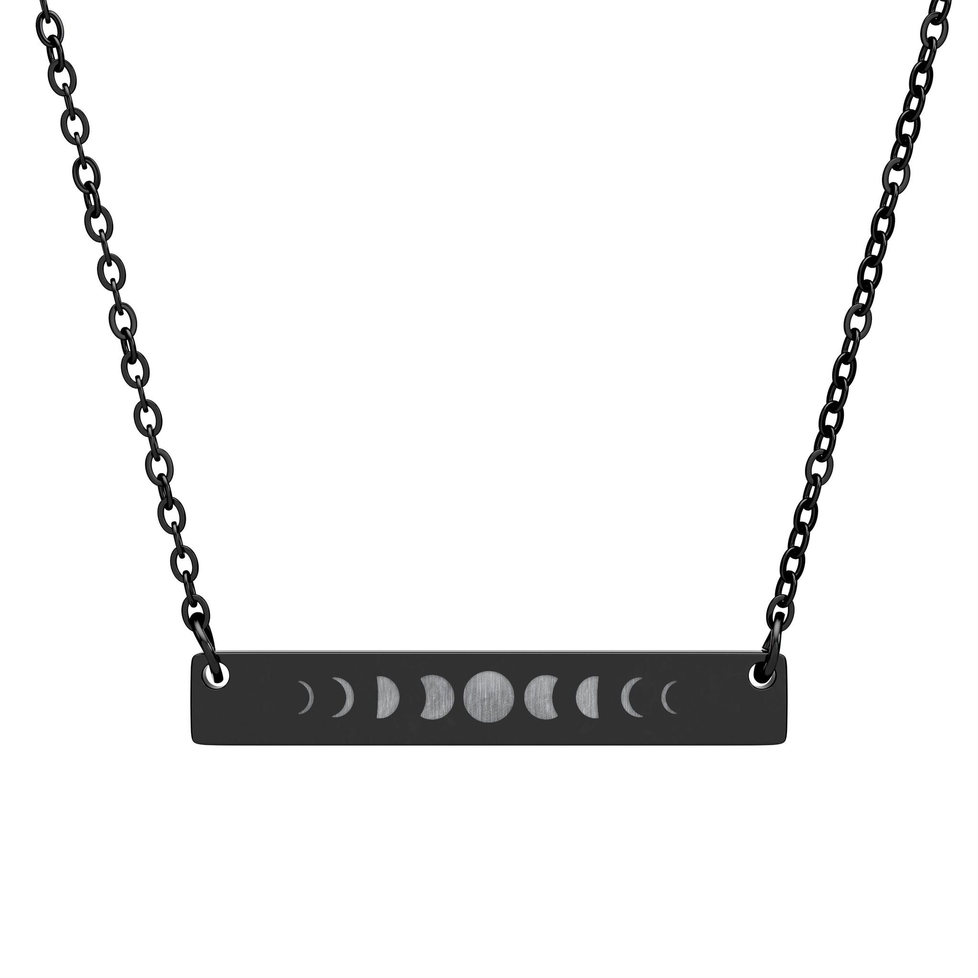 Black necklace with a horizontal bar pendant featuring moon phase symbols on a white background