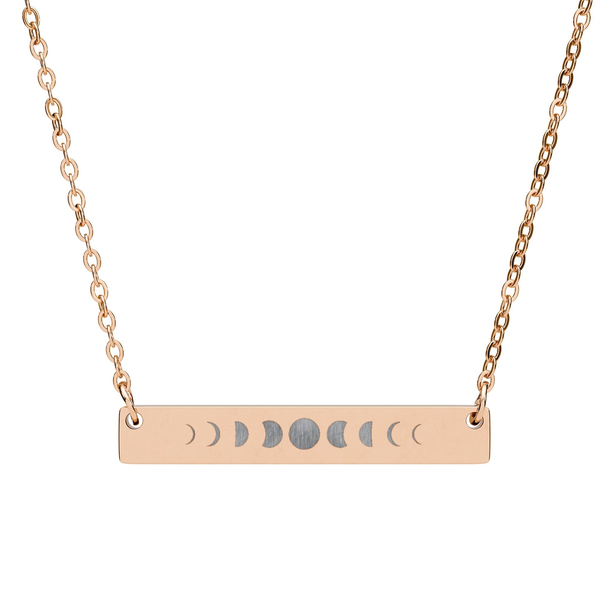 Rose gold necklace with a horizontal bar pendant featuring moon phase symbols on a white background.
