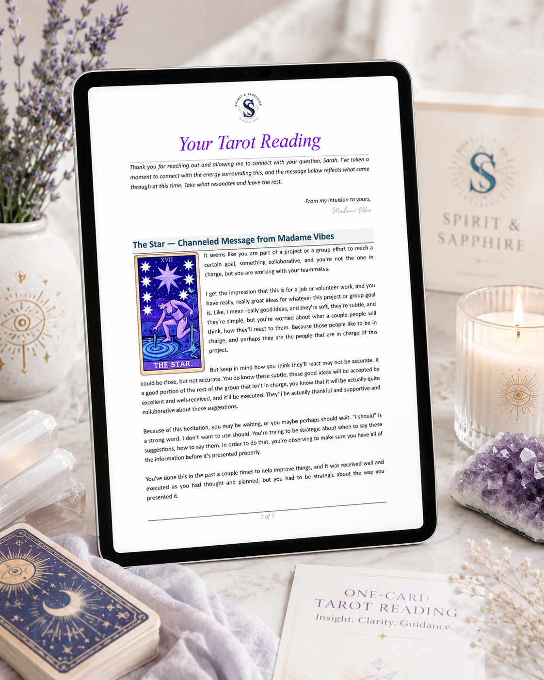 Tablet displaying a tarot reading with tarot cards, candles, and crystals on a table.