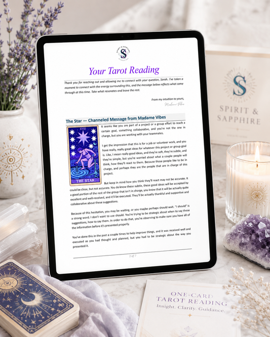 Tablet displaying a tarot reading with tarot cards, candles, and crystals on a table.